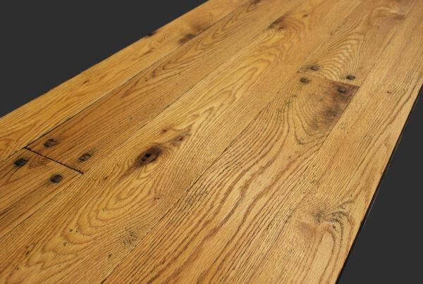 Hand scraped wide plank red oak flooring with raised pegs, smoke accents and Harvest pine colored hard wax oil finish