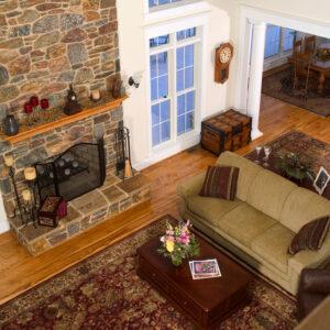 wide plank hickory floor surrounding fireplace in PA country home